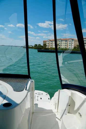 Kaizen Yacht Photos Pics View from 2007 Cruisers Yachts 560 Express, overlooking serene waters and distant buildings.