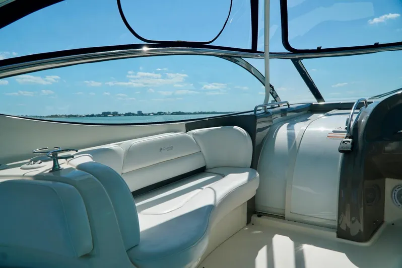 Kaizen Yacht Photos Pics Interior of 2007 Cruisers Yachts 560 Express with white seating and panoramic windows.