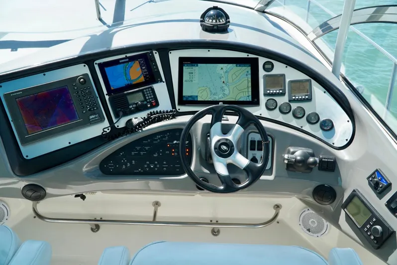 Kaizen Yacht Photos Pics 2007 Cruisers Yachts 560 Express helm with navigation screens and controls.