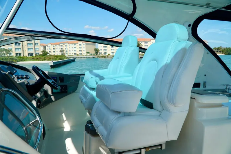 Kaizen Yacht Photos Pics 2007 Cruisers Yachts 560 Express helm with luxurious seating and waterfront view.