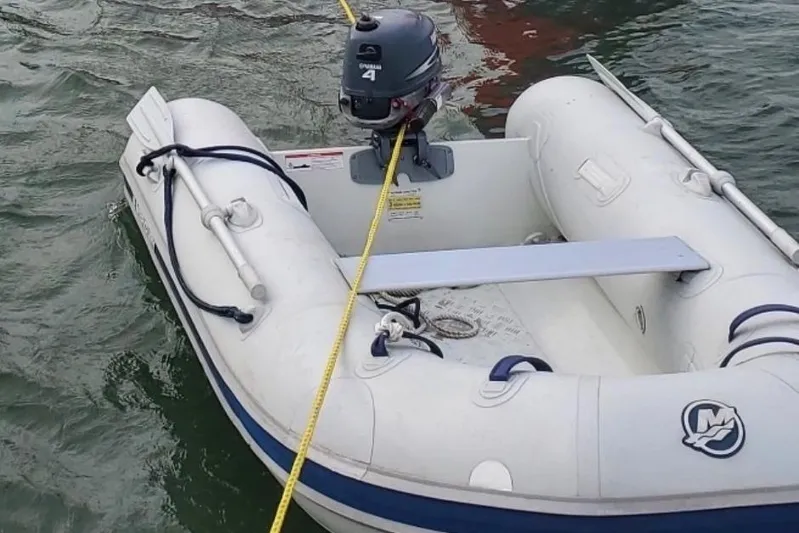 Gemini's Escape II Yacht Photos Pics Inflatable dinghy with Yamaha outboard motor, tethered to a Beneteau Oceanis 42CC, 2005 model.