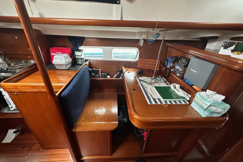 Gemini's Escape II Yacht Photos Pics Interior of 2005 Beneteau Oceanis 42CC sailboat with navigation station and wooden finish.