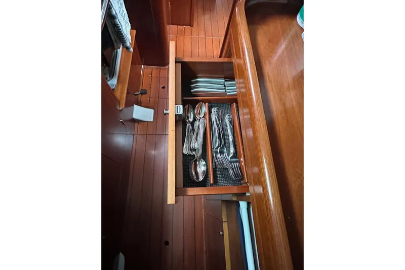 Gemini's Escape II Yacht Photos Pics Open drawer with cutlery and napkins on Beneteau Oceanis 42CC, 2005 model yacht.