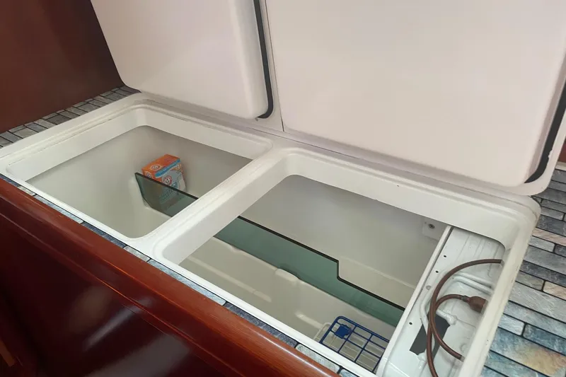 Gemini's Escape II Yacht Photos Pics Open storage compartment in 2005 Beneteau Oceanis 42CC yacht interior.