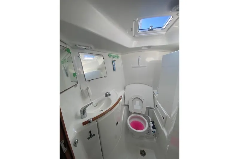 Gemini's Escape II Yacht Photos Pics Bathroom interior of 2005 Beneteau Oceanis 42CC yacht, featuring sink and toilet.