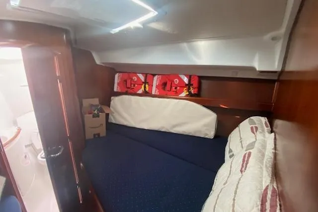 Gemini's Escape II Yacht Photos Pics Cozy cabin interior of 2005 Beneteau Oceanis 42CC sailboat with bed and storage.