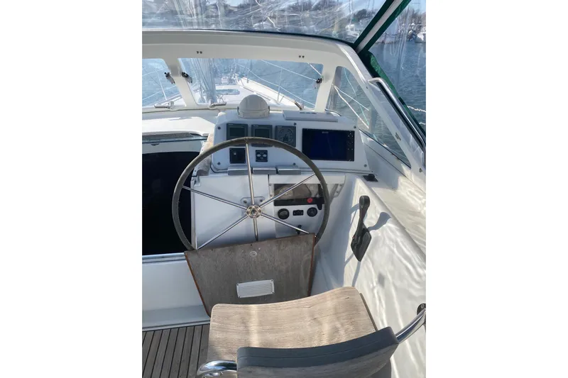 Gemini's Escape II Yacht Photos Pics Cockpit of 2005 Beneteau Oceanis 42CC sailboat with steering wheel and navigation instruments.