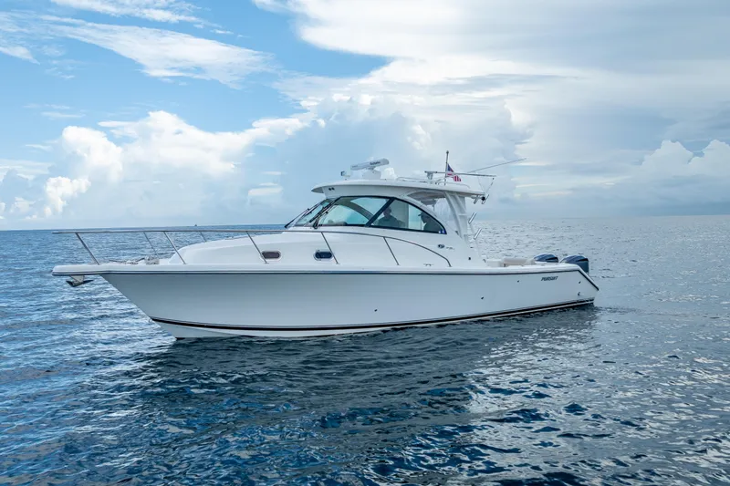 "seven C's" Yacht Photos Pics 2011 Pursuit OS 345 Offshore boat on calm ocean under cloudy sky.