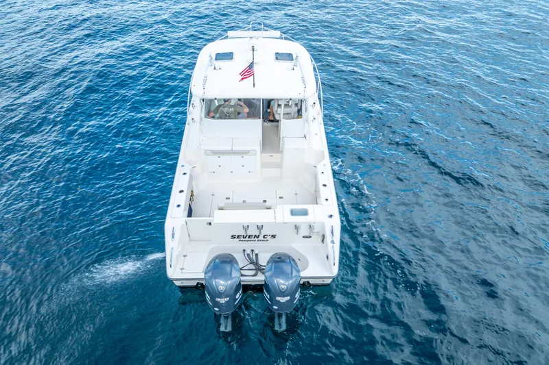 "seven C's" Yacht Photos Pics 2011 Pursuit OS 345 Offshore boat on open water, rear view with dual engines.