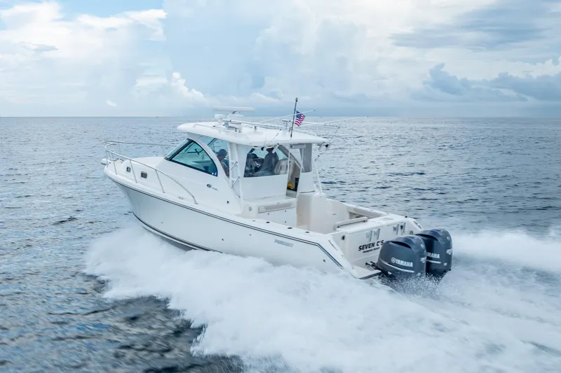 "seven C's" Yacht Photos Pics 2011 Pursuit OS 345 Offshore boat cruising on open water under cloudy skies.