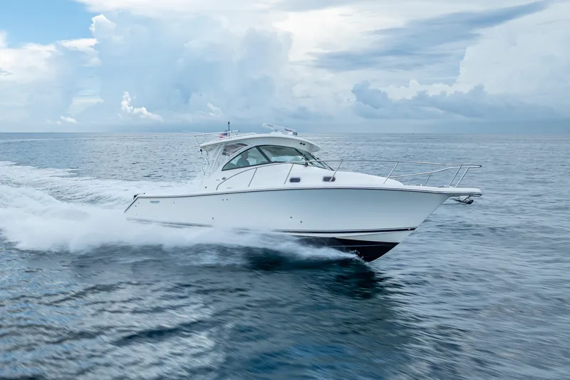 "seven C's" Yacht Photos Pics 2011 Pursuit OS 345 Offshore boat cruising on open water under cloudy skies.