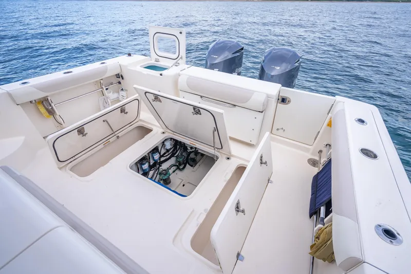 "seven C's" Yacht Photos Pics 2011 Pursuit OS 345 Offshore boat deck with open storage compartments and dual engines.
