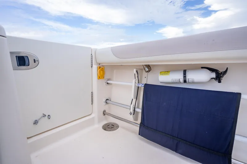 "seven C's" Yacht Photos Pics 2011 Pursuit OS 345 Offshore boat interior with safety equipment and storage.