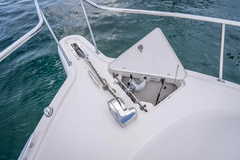 "seven C's" Yacht Photos Pics 2011 Pursuit OS 345 Offshore boat anchor compartment with chain, on calm water.