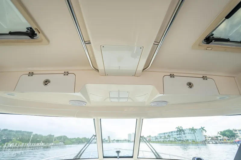 "seven C's" Yacht Photos Pics Interior view of 2011 Pursuit OS 345 Offshore boat, showcasing ceiling storage compartments.