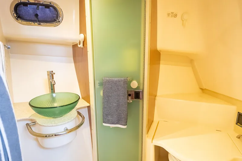 "seven C's" Yacht Photos Pics 2011 Pursuit OS 345 Offshore bathroom with glass sink and modern fixtures.