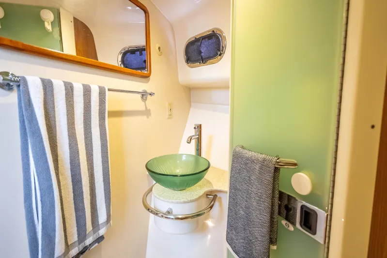 "seven C's" Yacht Photos Pics 2011 Pursuit OS 345 Offshore bathroom with glass sink and striped towel.