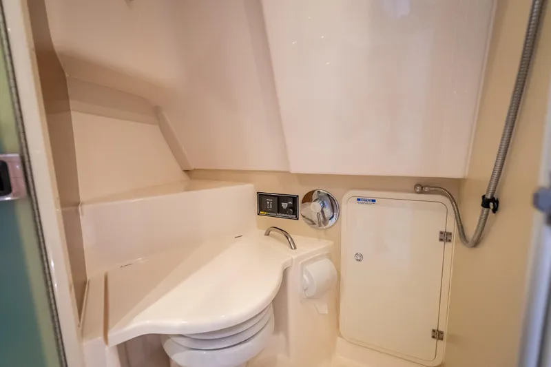 "seven C's" Yacht Photos Pics 2011 Pursuit OS 345 Offshore boat bathroom with compact design and modern fixtures.