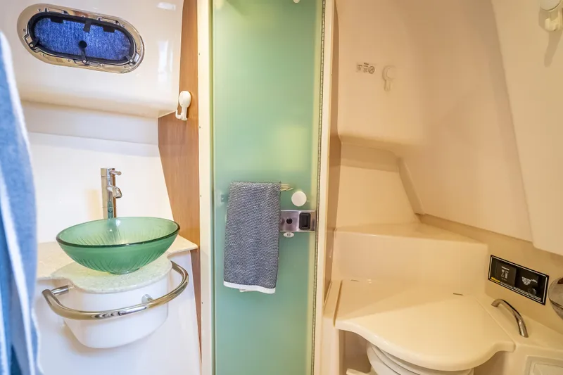 "seven C's" Yacht Photos Pics 2011 Pursuit OS 345 Offshore bathroom with glass sink and modern fixtures.