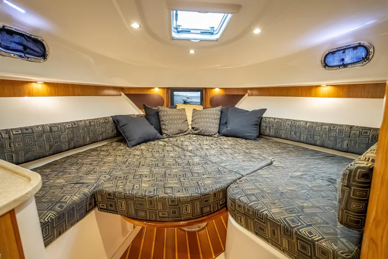 "seven C's" Yacht Photos Pics Luxurious cabin interior of 2011 Pursuit OS 345 Offshore boat with cozy seating and cushions.
