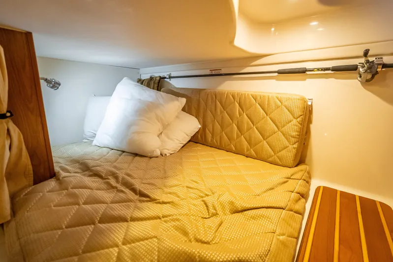 "seven C's" Yacht Photos Pics Cozy cabin interior of 2011 Pursuit OS 345 Offshore with quilted bedding and pillows.