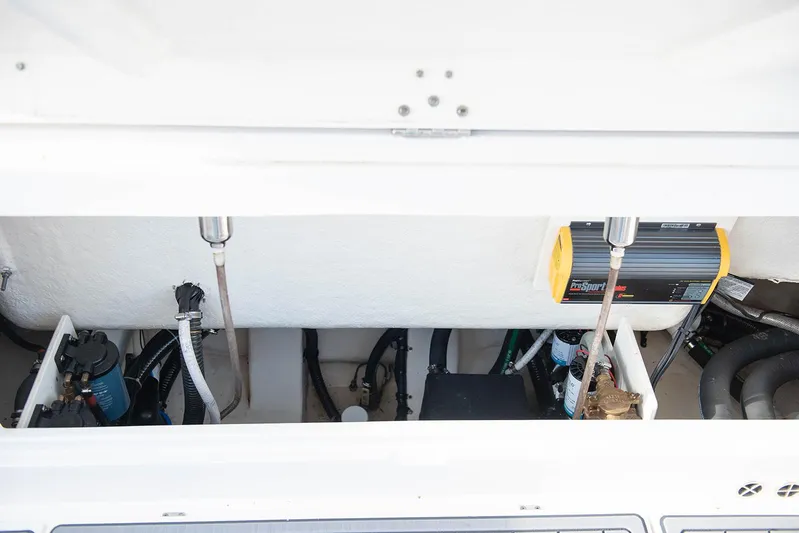  Yacht Photos Pics 2020 Robalo R302 CC boat engine compartment with various mechanical components.