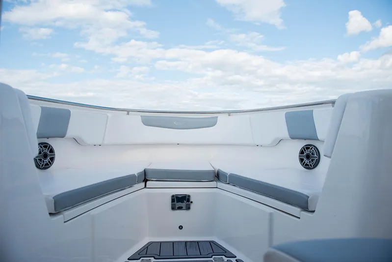  Yacht Photos Pics 2020 Robalo R302 CC boat interior with cushioned seating and speakers.
