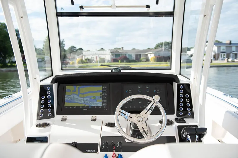  Yacht Photos Pics 2020 Robalo R302 CC boat dashboard with navigation screens and steering wheel.