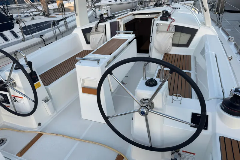 Barcelona Yacht Photos Pics 2021 Beneteau Oceanis 35.1 yacht cockpit with dual steering wheels and teak seating.