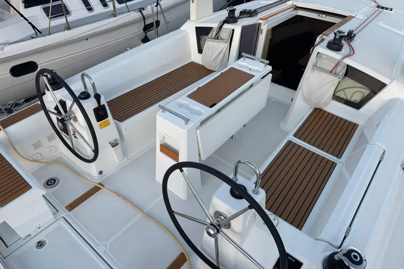 Barcelona Yacht Photos Pics 2021 Beneteau Oceanis 35.1 yacht cockpit with dual steering wheels and teak seating.