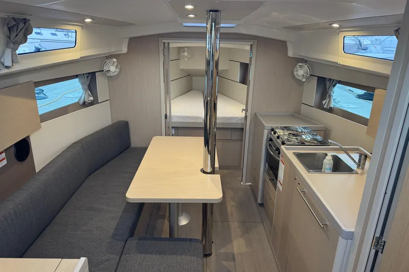 Barcelona Yacht Photos Pics Interior of 2021 Beneteau Oceanis 35.1 yacht with modern kitchen and seating area.
