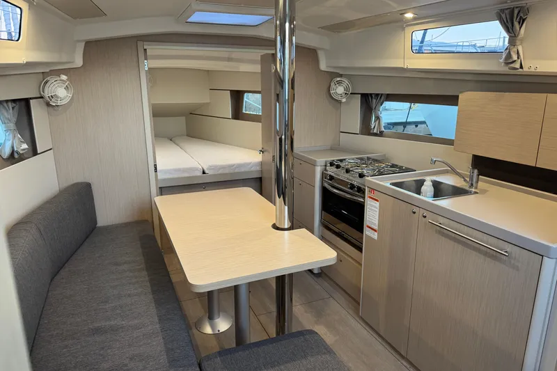 Barcelona Yacht Photos Pics Interior of 2021 Beneteau Oceanis 35.1 yacht with modern kitchen and dining area.