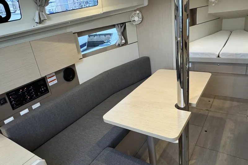 Barcelona Yacht Photos Pics Interior of 2021 Beneteau Oceanis 35.1 yacht with modern seating and dining area.