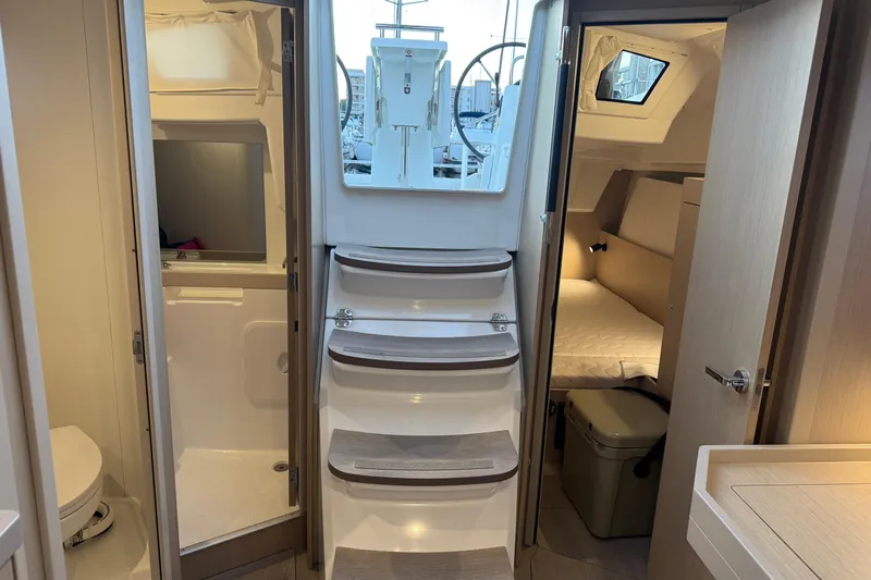 Barcelona Yacht Photos Pics Interior of 2021 Beneteau Oceanis 35.1 yacht, featuring stairs, cabin, and bathroom.