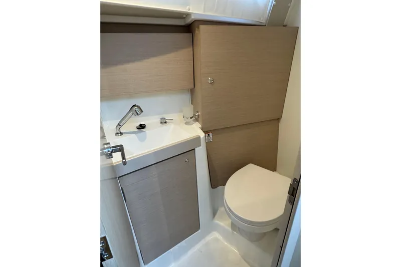 Barcelona Yacht Photos Pics Compact bathroom in 2021 Beneteau Oceanis 35.1 yacht, featuring sink and toilet.
