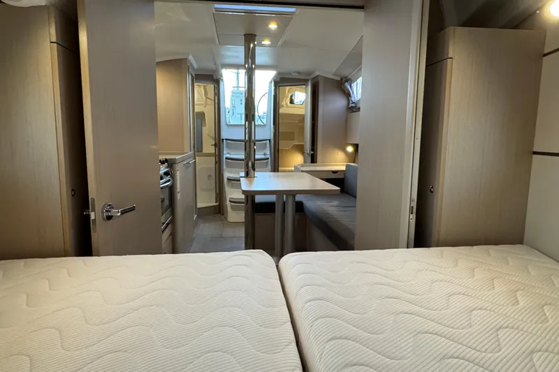 Barcelona Yacht Photos Pics Interior of 2021 Beneteau Oceanis 35.1 yacht, featuring cozy cabin and dining area.