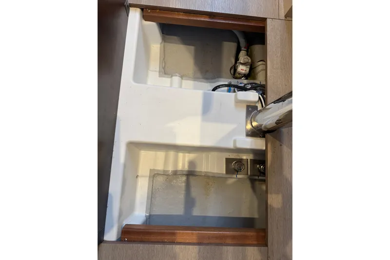 Barcelona Yacht Photos Pics Bilge compartment of 2021 Beneteau Oceanis 35.1 sailboat, featuring plumbing and wiring.