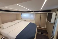 Luxurious cabin interior of 2023 Cranchi F 52 yacht with modern design and cozy bedding.