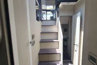 Interior staircase of 2023 Cranchi F 52 yacht, featuring modern design and wood finishes.