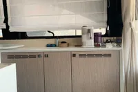 Modern kitchen interior in 2023 Cranchi F 52 yacht, featuring sleek cabinetry and appliances.