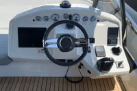 2023 Cranchi F 52 yacht helm with steering wheel, gauges, and navigation controls.
