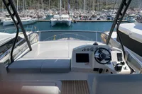 2023 Cranchi F 52 yacht helm with marina view, featuring modern controls and seating.