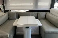 Luxurious interior of 2023 Cranchi F 52 yacht with sleek gray seating and modern table.