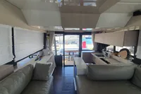 Luxurious interior of 2023 Cranchi F 52 yacht with modern kitchen and seating area.