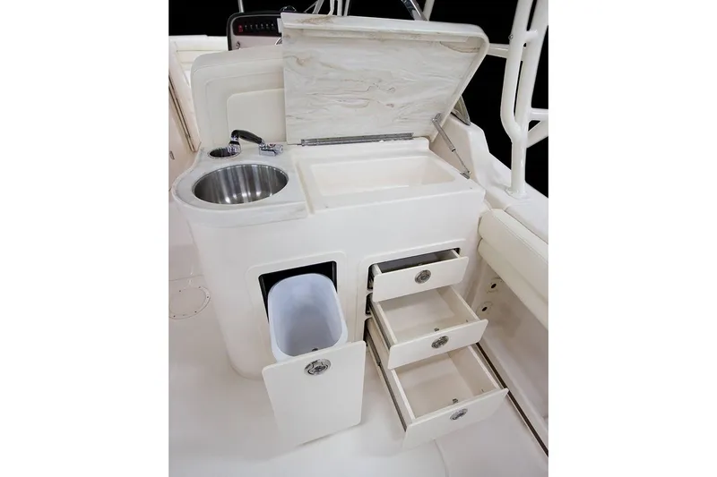 Plan B Yacht Photos Pics Manufacturer Provided Image: 2019 Grady-White Freedom 307 boat galley with sink, storage drawers, and trash bin.