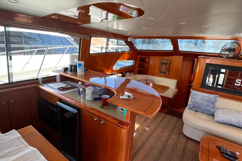The Donut Hull Yacht Photos Pics Luxurious interior of 2002 Mikelson 50 Flybridge yacht with elegant wood finishes.