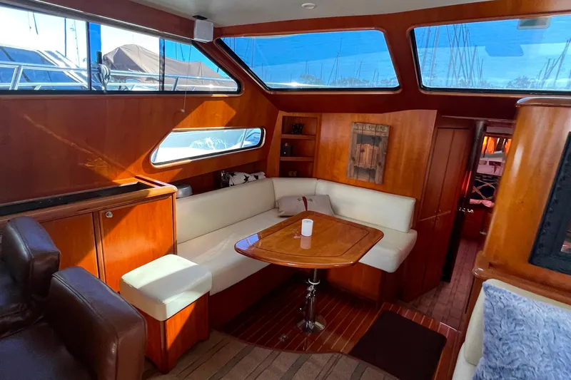 The Donut Hull Yacht Photos Pics Luxurious interior of 2002 Mikelson 50 Flybridge yacht with elegant wood finishes.