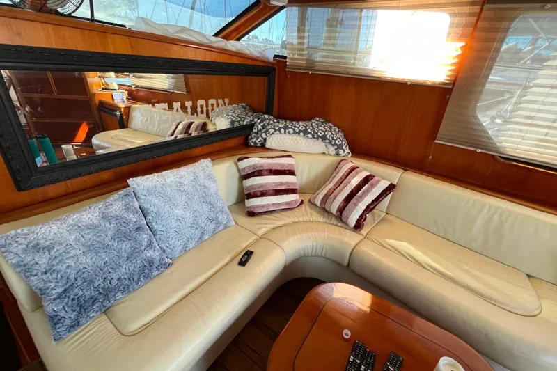 The Donut Hull Yacht Photos Pics Luxurious interior of 2002 Mikelson 50 Flybridge with plush seating and decorative pillows.