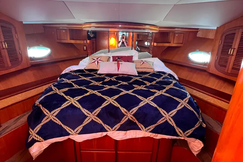 The Donut Hull Yacht Photos Pics Luxurious cabin interior of 2002 Mikelson 50 Flybridge yacht with nautical-themed bedding.