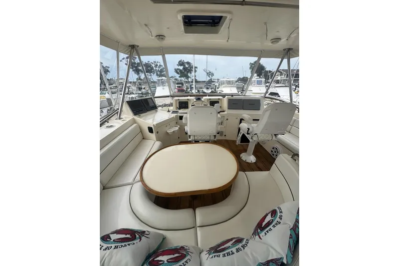 The Donut Hull Yacht Photos Pics 2002 Mikelson 50 Flybridge interior with helm, seating, and table, docked at marina.